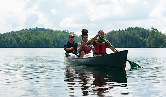Professor Matt Burnett canoes with two students from the Adirondack Experience class.