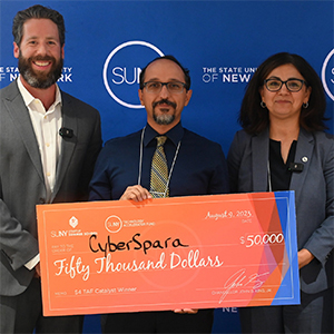 Cambia Ghazinour accepts a check from the SUNY Summer Startup School on behalf of CyberSpara.