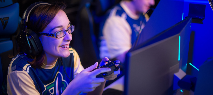 A student plays Fortnite with a game controller in the Esports Arena.