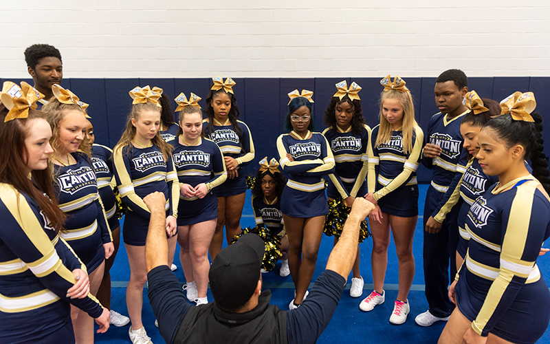 SUNY Canton cheerleading team receives guidance from coach Joey Boswell.