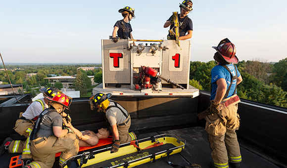 Canton Firefighters practice a rooftop extraction from the top of MacArthur Hall.