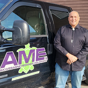 Andre White stands next to his AME branded black truck.