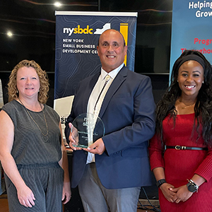 Andre White of AME Equipment LLC receives the 2024 Growth Company of the Year award along with Michelle Collins and Sonya Smith.