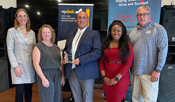 Andre White of AME Equipment LLC receives the 2024 Growth Company of the Year award along with Lenore VanderZee, Michelle Collins, Sonya Smith and Dale Rice.