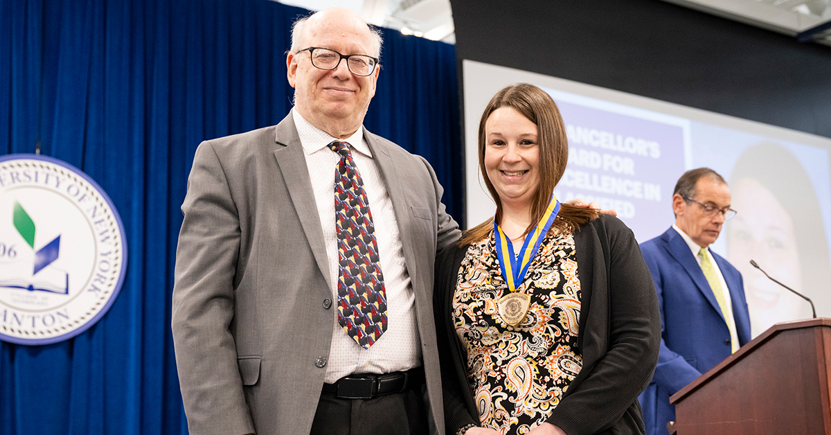 Chancellor's Award winner Amanda Carr and President Zvi Szafran pose on stage at Recognition Day.