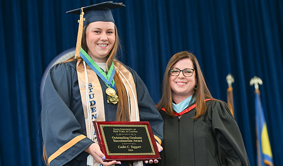 Cadin Taggart is presented with the Outstanding Graduate Award by Vice President Courtney Bish.