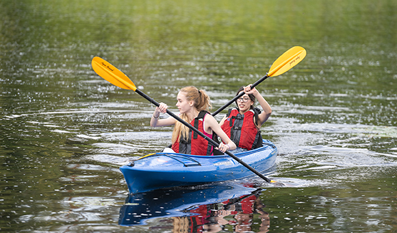 Students from SUNY Canton’s Educational Opportunity Program take an evening kayak adventure on the Grasse River.