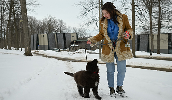 Erin Stickney walks with her puppy, Wooly.
