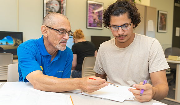 Fred Saburro works with a student in the Tutoring Lab.