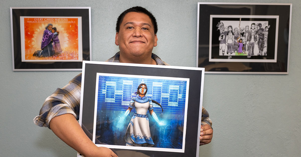 Honni David holds up his fan art of Marvel's Mohawk character, Kahhori.