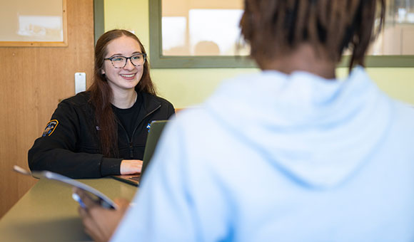 Isabella Joy works with a student in Southworth Library.