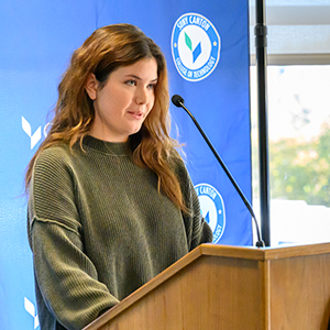 Jacquelyn Rainville speaks from a podium during the ASAP|ACE event.
