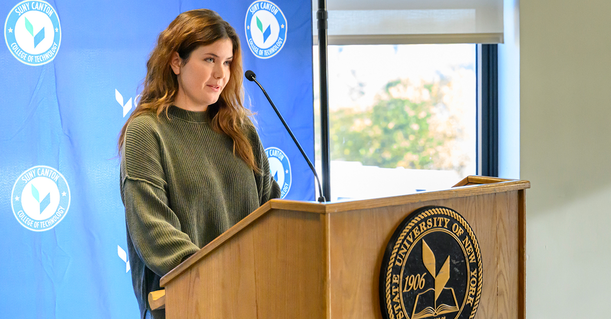 Student Jacquelyn Rainville speaks at a podium during the ASAP|ACE event.