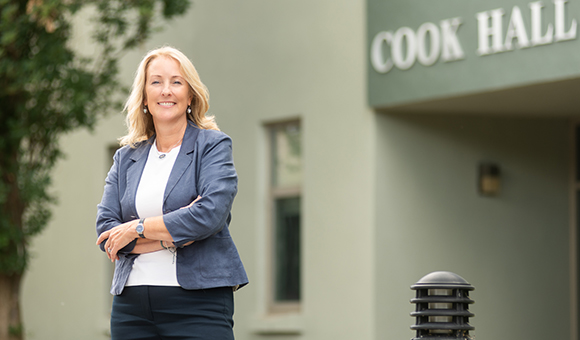 Michele Snyder stands outside Cook Hall.