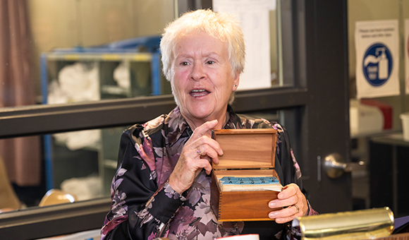 Paula Bouchard-Jacques holds a box of index cards containing treatment and medication preparation.