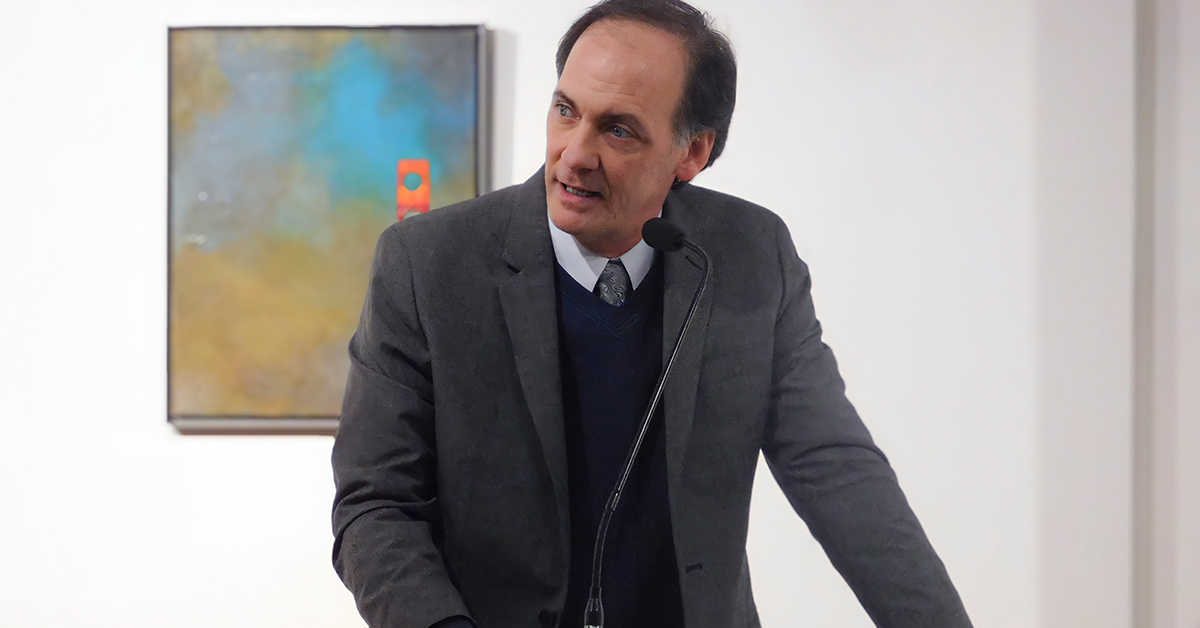 Peter Rossum stands at a podium