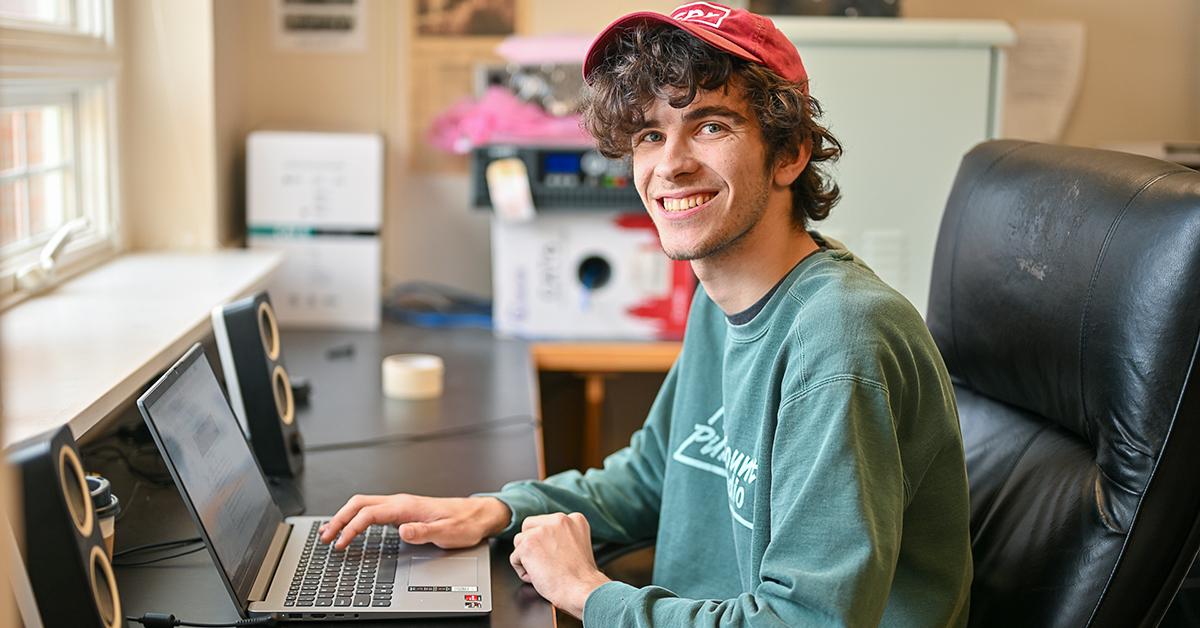 Richard Haller sits at desk with a laptop.