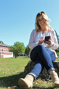 Sara Sharlow sitting while on her smart phone.