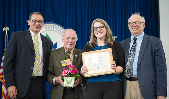 Sarah Todd accepts the Presidential Meritorious Service Award from Randy Sieminski, Ronald O'Neill, President Szafran.