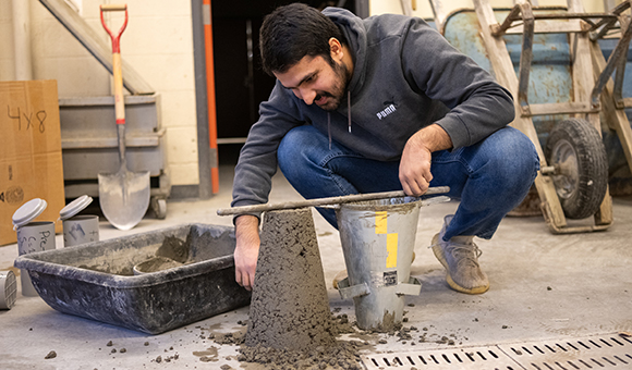 Waleed Sardar levels off a concrete cylinder.