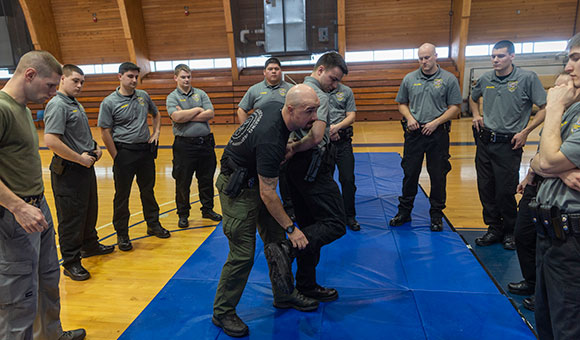 City of Ogdensburg Patrolman Ryan Polniak demonstrates arrest techniques with cadet Joshua Belile during a class in the David Sullivan-St. Lawrence County Law Enforcement Academy.