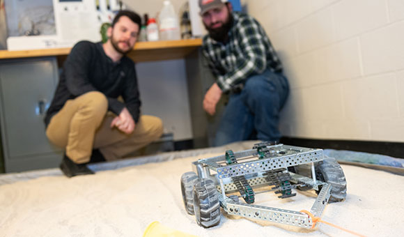 Owen Kuca and Patrick Taillon and their “Beach Roomba” device designed to help clean North Country beaches