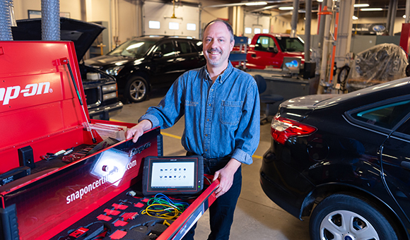 Brandon Baldwin stands with Snap-On tools in the Automotive lab.