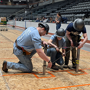 George Staats, Ciara McDougal and Ryan Willard assemble a portion of the college&rsquo;s bridge.