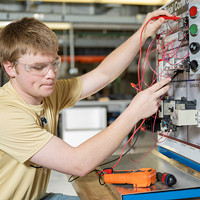 A student tests some building system controls in the HVAC lab.