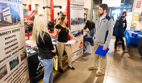 A student speaks with AES representatives about job opportunities at the 2019 Career Fair.