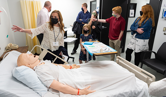 Members of the Caswell family tour the simulation labs, which feature computer-controlled nursing manikins.