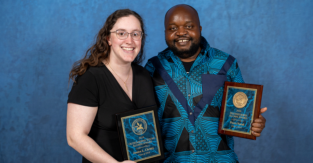 Jessica Christy and Pierre Nzuah holding their Alumni Awards.