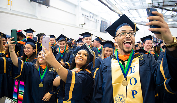 Students taking selfies at graduation