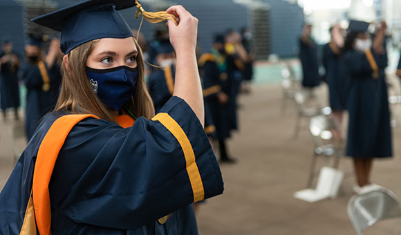 Sydney Uthe switches her tassel.