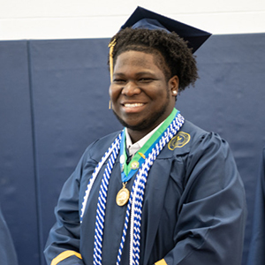 A graduate is all smiles at the 115th Commencement Ceremony.