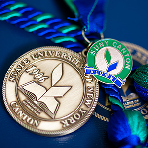 Commencement medallion and alumni pin