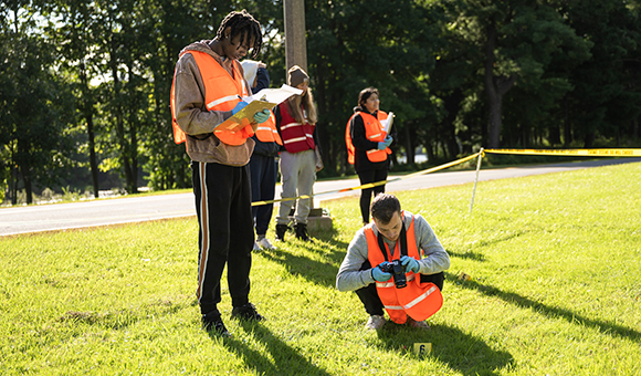 Criminal Investigation students gather evidence from a mock crime scene.