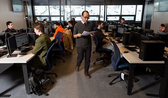 Kambiz Ghazinour walks around the new Cybersecurity lab.