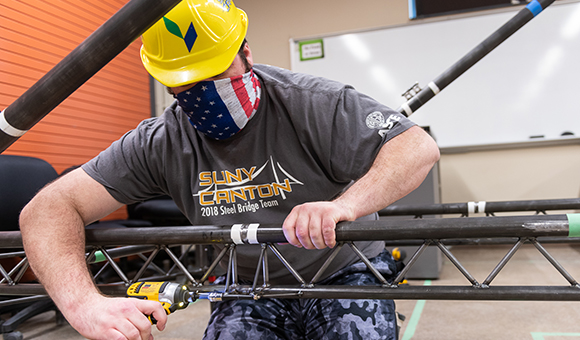 Dale Harris tightens a bolt on the 2021 steel bridge entry.