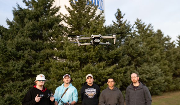 Students fly a drone near the SUNY Canton water tower.