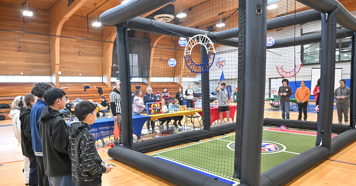 Students competing at drone soccer in Dana Hall.