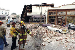 Emergency personnel inspect damage from an earthquake.