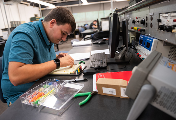 Lucas Harbor of Heuvelton builds a circuit in SUNY Canton’s Electrical Engineering Technology laboratory.