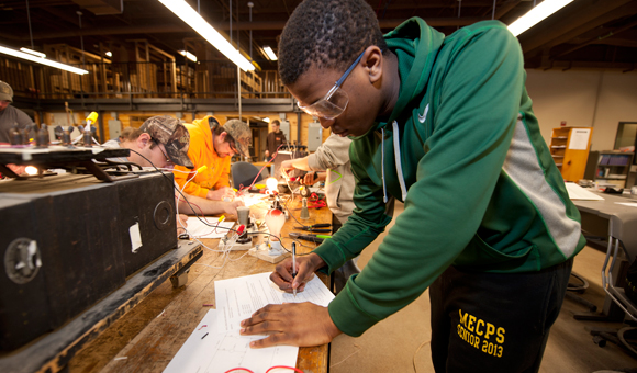 A student writes notes in the ECM lab