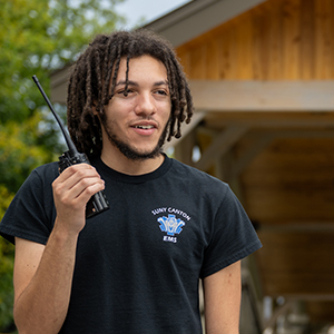 Tashmir Eggleston tests a radio near the SUNY Canton footbridges.