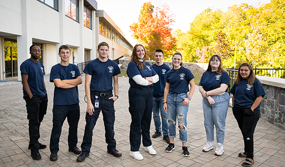 The EMS Squad stands outside Rendezvous on a beautiful fall day.