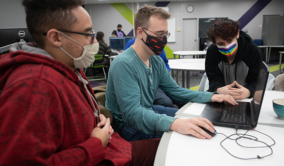 A group of game design students work on their game titled 