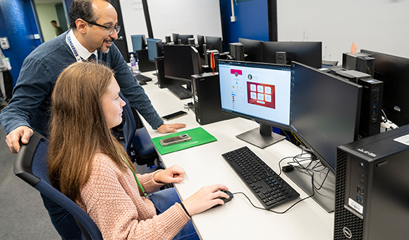 Kambiz Ghazinour works with a student using DigitalPASS in the Cybersecurity lab.