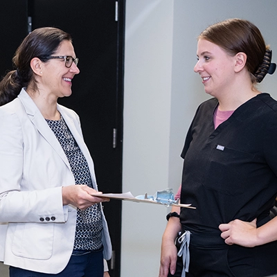 A healthcare manager works with a nurse.