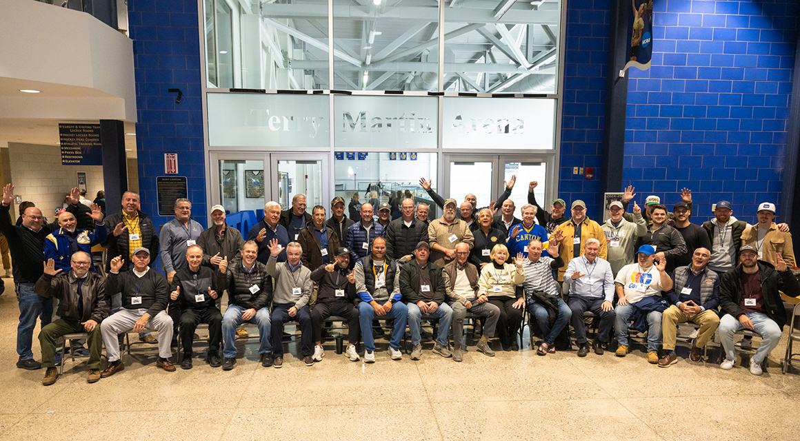 SUNY Canton hockey alumni gathered for a group photo in front of the new Terry Martin Arena entrance.